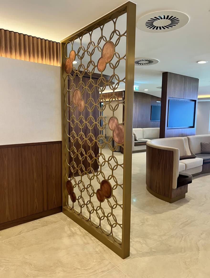 Bespoke brass circle screen with antique copper inserts manufactured by MorFabrication for Everton Stadium Owners Bar