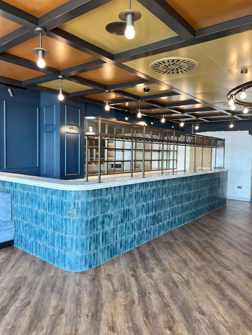 Domingos Bar and Grill featuring bespoke brass and mesh bar gantry at Everton Stadium