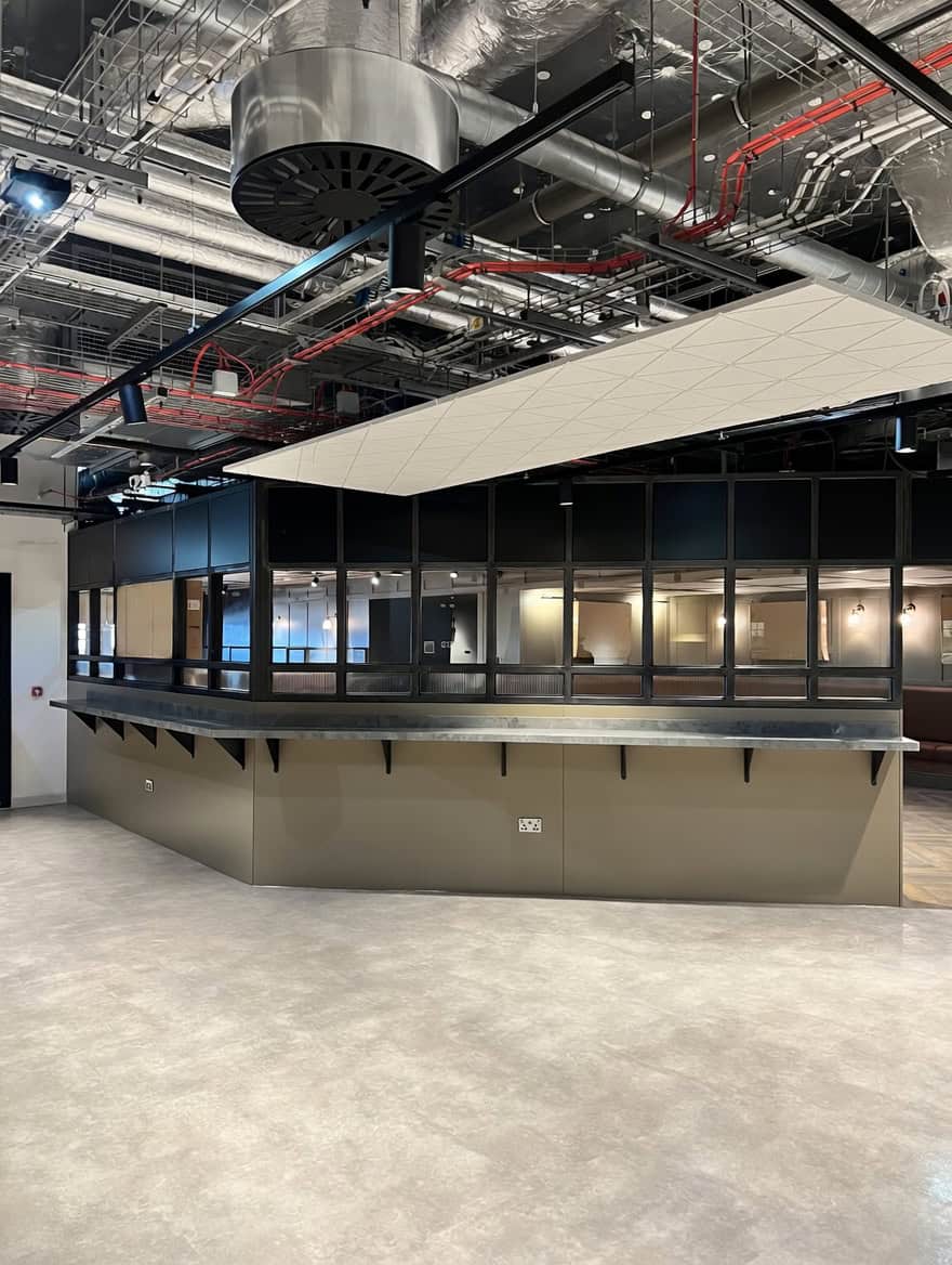 Large hospitality bar counter with zinc top and blackened steel framework at Everton Stadium
