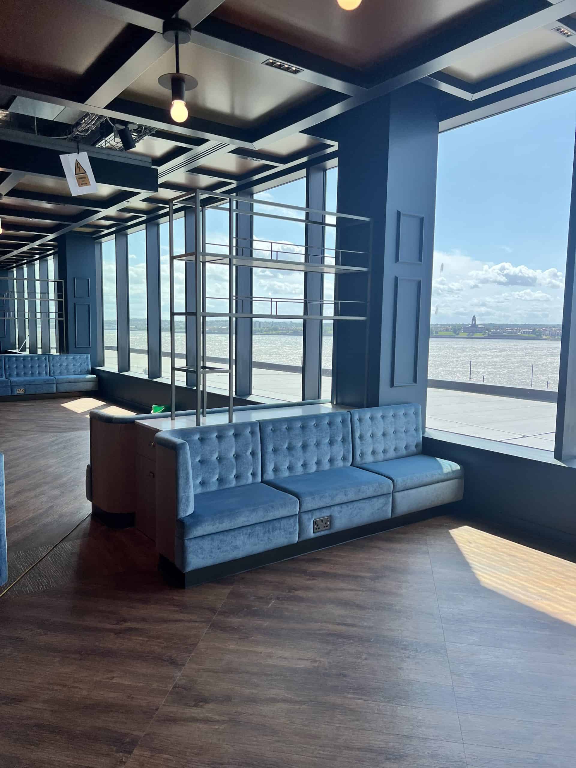 Steel-framed hospitality booth seating with panoramic views at Everton Stadium West Stand