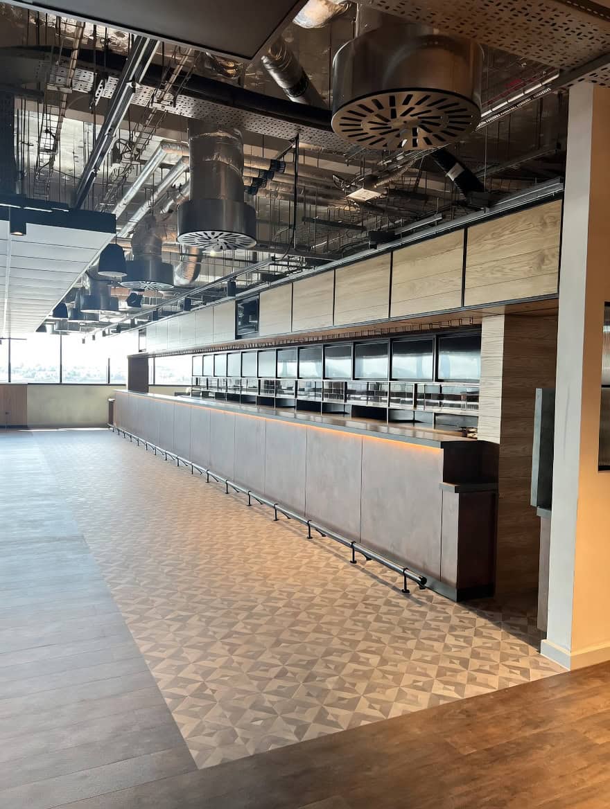 Full-length powder coated servery bar with illuminated panels at Everton Stadium