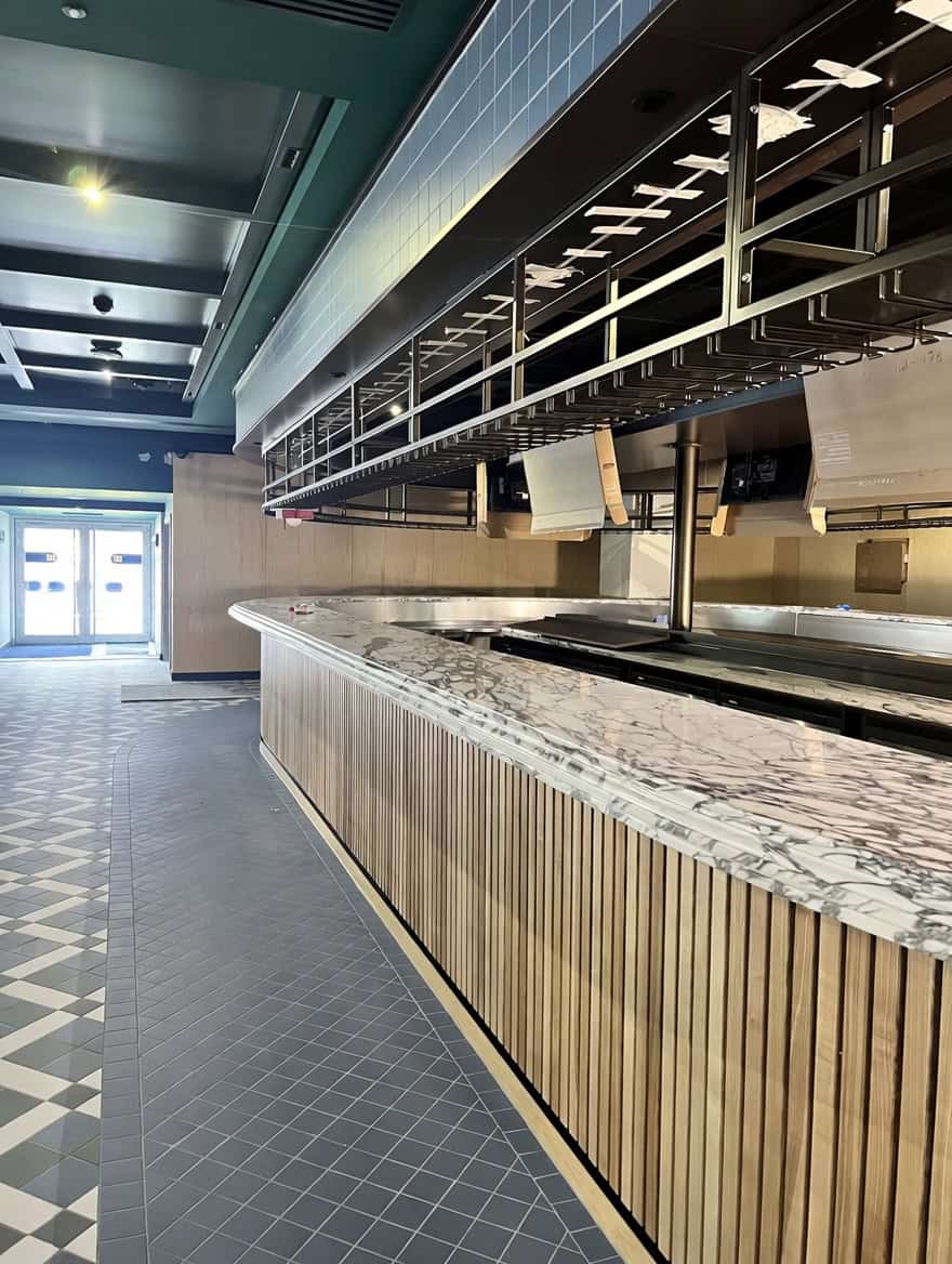 Stainless steel servery counter with overhead gantry at Everton Stadium West Stand